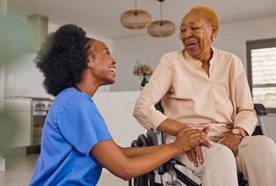 Medical assistant talking to elderly patient