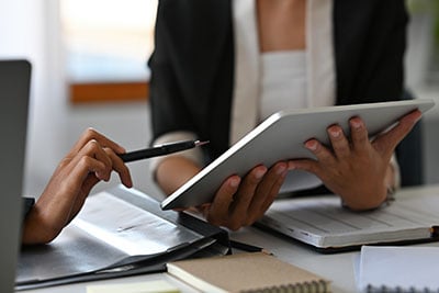 Two people consulting a tablet