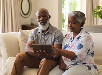 Elderly couple staring at tablet