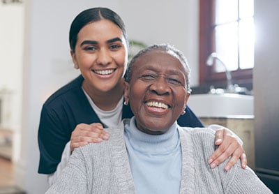 A medical assistant smiling with an elderly patient