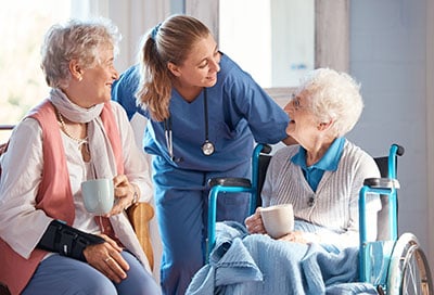 Medical Assistant speaking with two older patients